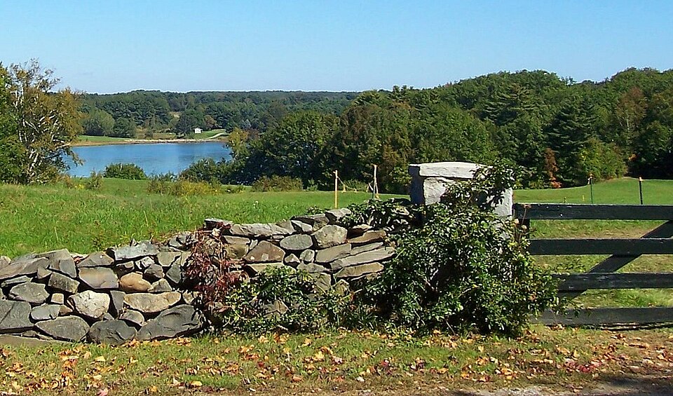 The York River seen from Southside Road in York, Maine — open water beyond a field and a stone wall